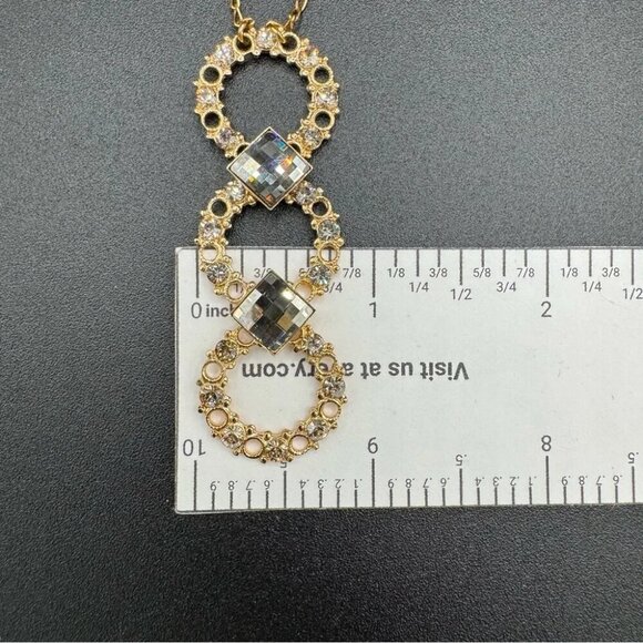 Belladonna Circular Crystal and Gold Tone Infinity Pendant Necklace - Picture 7 of 17